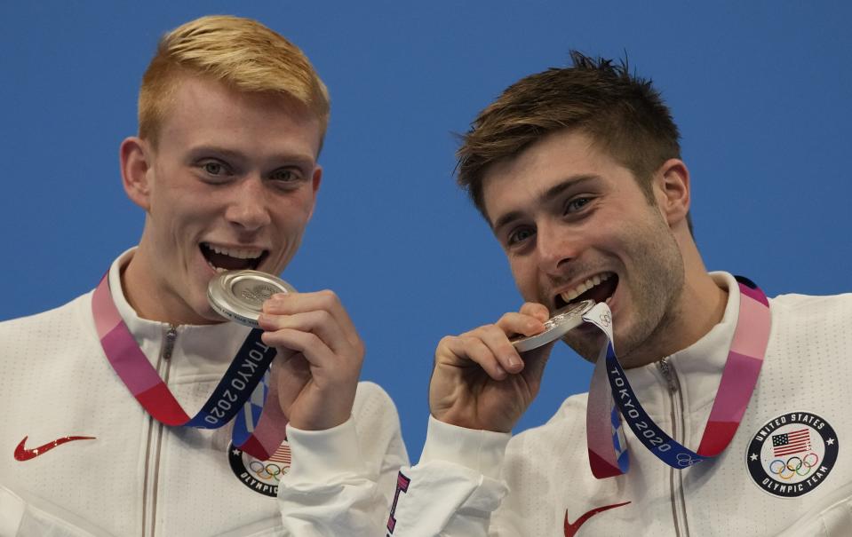 Andrew Capobianco and Michael Hixon of the United States' pose for photo after winning silver medals during the men's Synchronized 3m Springboard Final at the Tokyo Aquatics Centre at the 2020 Summer Olympics, Wednesday, July 28, 2021, in Tokyo, Japan. (AP Photo/Dmitri Lovetsky)