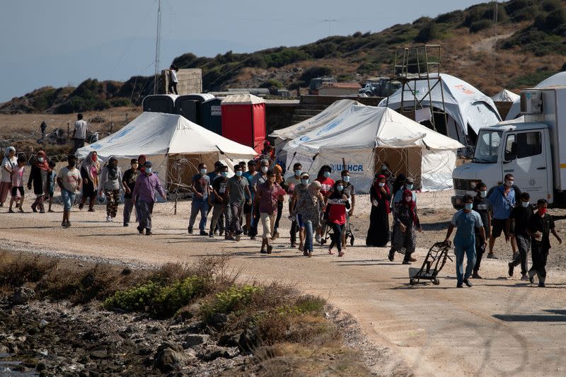 Refugees and migrants from the destroyed Moria camp are seen inside a new temporary camp, on the island of Lesbos