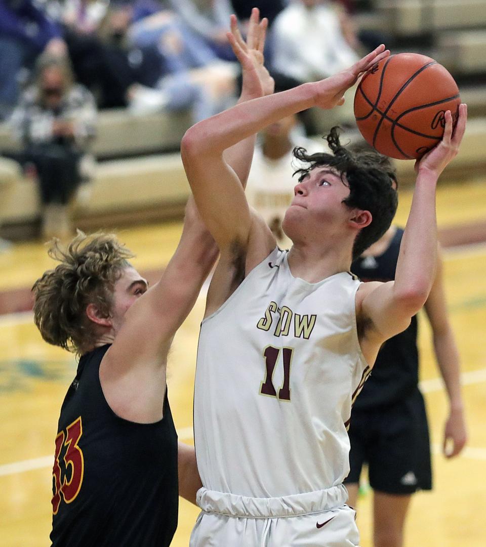 Stow's AJ Pestello Jr., right, looks to shoot over Brecksville's Chase Garito during the second half of a 2021-22 boys basketball game in Stow