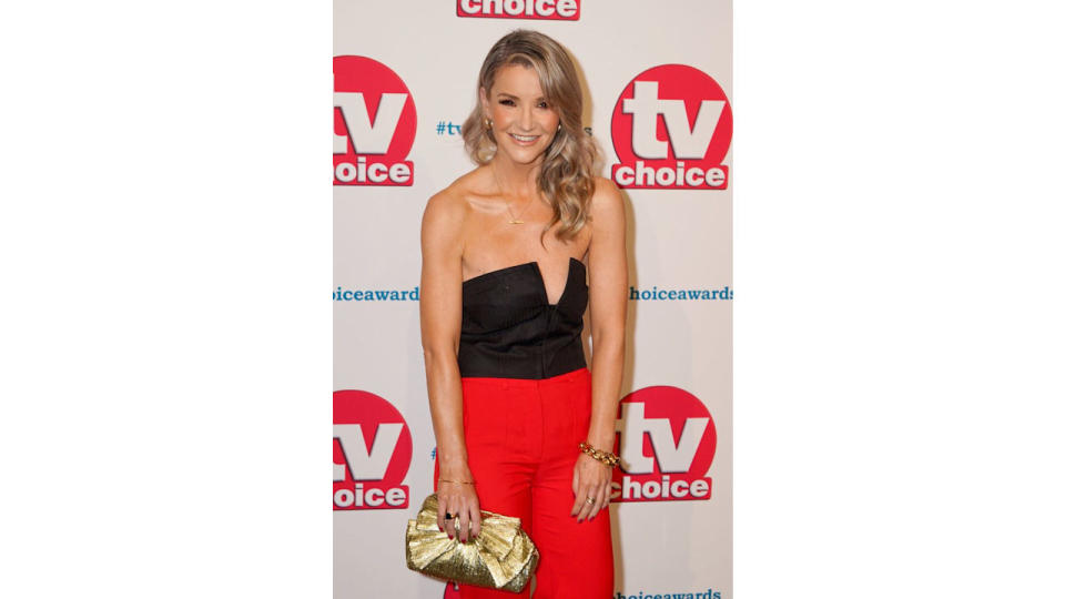 Helen Skelton in a black bustier and red trousers on the red carpet