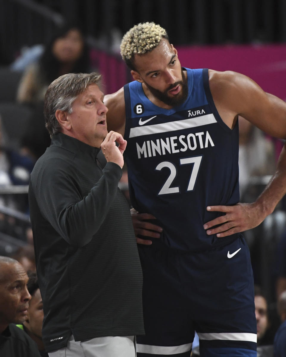 Minnesota Timberwolves head coach Chris Finch talks with Minnesota Timberwolves center Rudy Gobert (27) during the first half of an NBA preseason basketball game against the Los Angeles Lakers Thursday, Oct. 6, 2022, in Las Vegas. (AP Photo/Sam Morris)