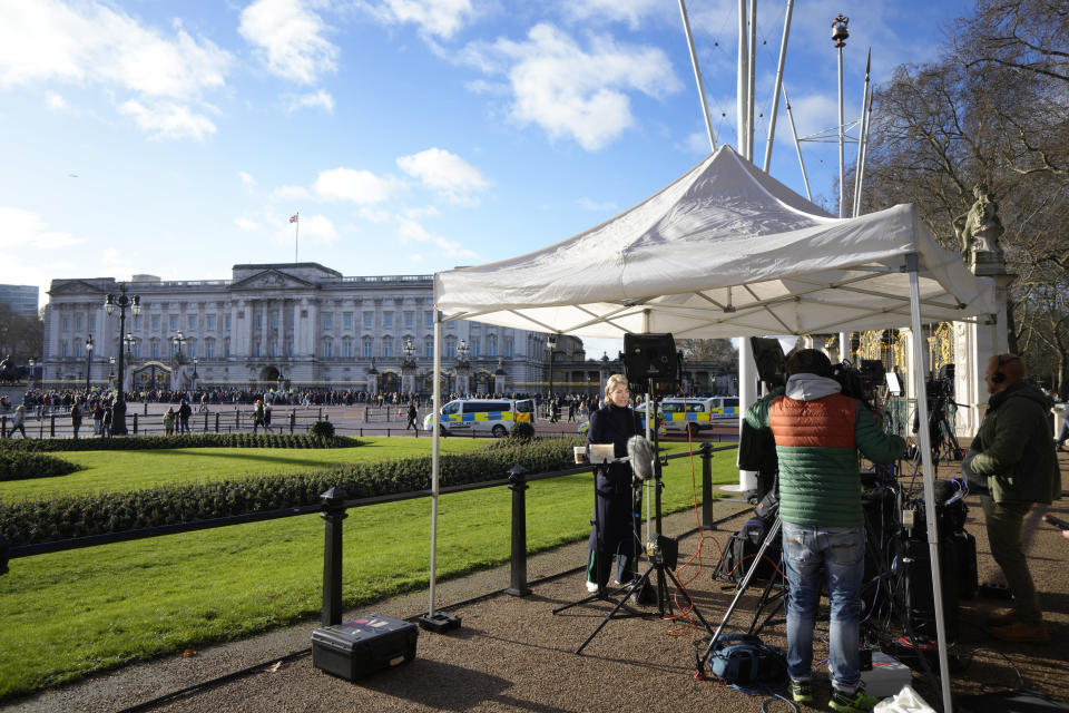 Television crews film near Buckingham Palace in London, Monday, Jan. 9, 2023. Prince Harry has defended his memoir that lays bare rifts inside Britain's royal family. He says in TV interviews broadcast Sunday that he wanted to "own my story" after 38 years of "spin and distortion" by others. Harry's soul-baring new memoir, "Spare," has generated incendiary headlines even before its release. (AP Photo/Kirsty Wigglesworth)