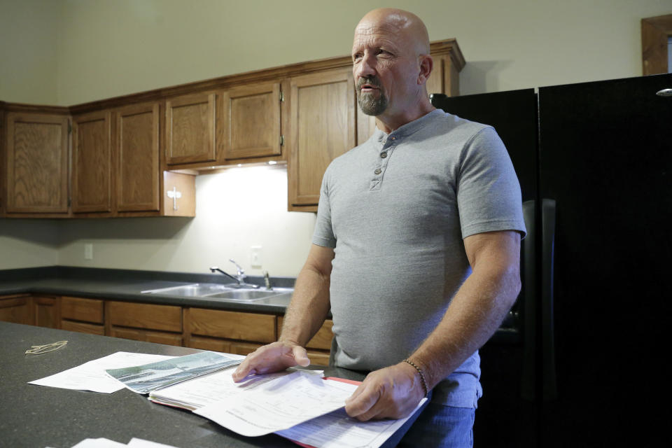 Former San Jacinto County Deputy Michael Flynt, holds documents detailing his issues with the Sheriff's office, during an interview Tuesday, May 16, 2023, in Shepard, Texas. When Flynt brought up violations in policy, procedure and law at the department, he was fired from the sheriff's office, and his name was smeared. He prevailed in a subsequent whistleblower lawsuit. (AP Photo/Michael Wyke)