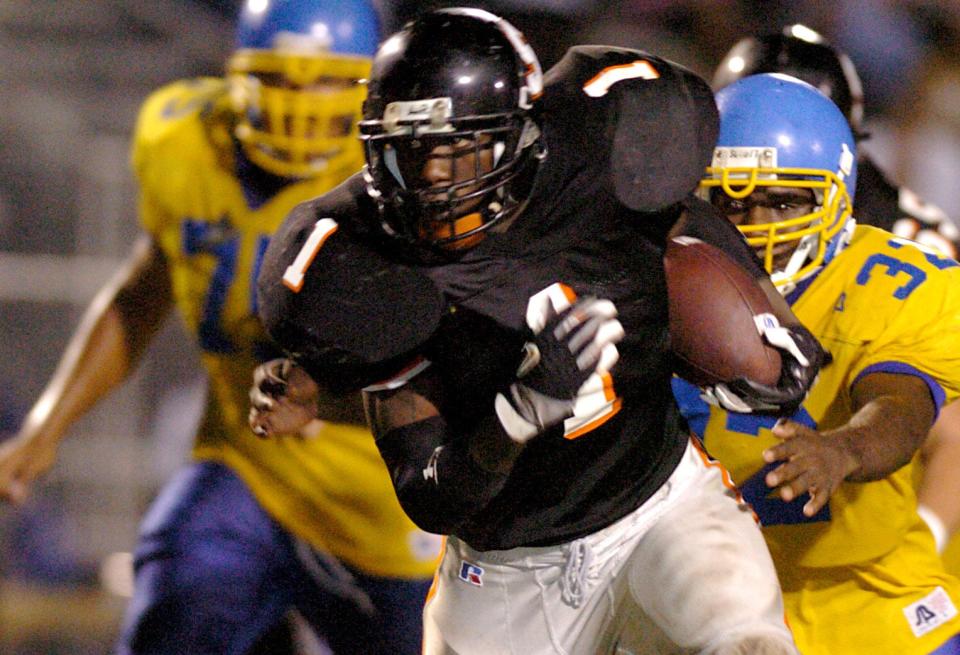 Sarasota running back Mike Ford gets away from Gibbs defenders in the third quarter during the 5A Region 3 semifinals at Sarasota High School, Friday, November 19, 2004.