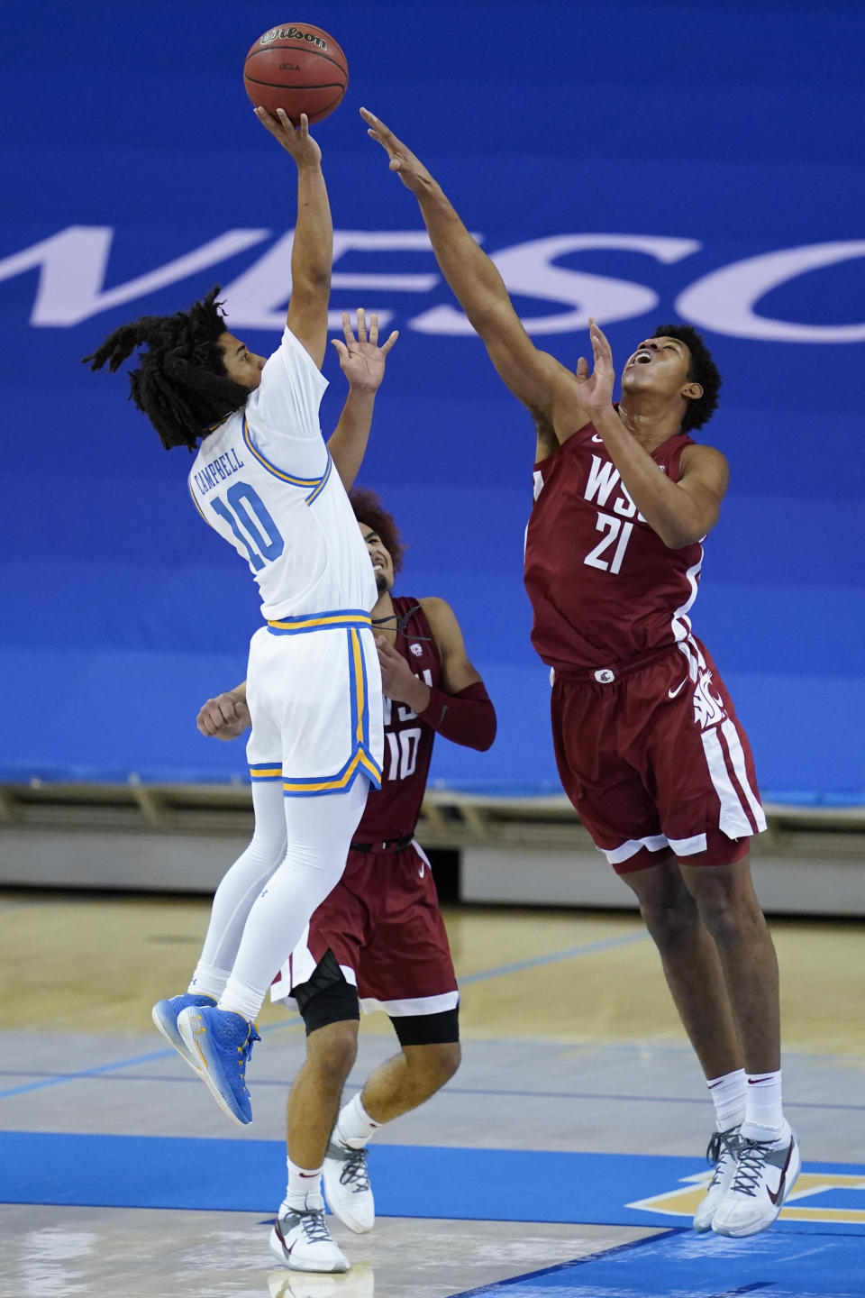 UCLA guard Tyger Campbell (10) shoots against Washington State center Dishon Jackson (21) during the first half of an NCAA college basketball game Thursday, Jan. 14, 2021, in Los Angeles. (AP Photo/Ashley Landis)