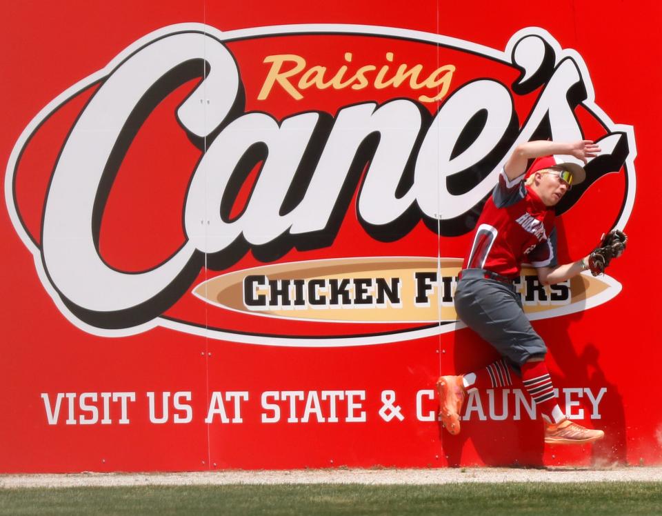 Rossville Hornets outfielder Quynten Saylor (22) collides with the outfield fence during the IHSAA baseball regional game against the Central Catholic Knights, Saturday, June 3, 2023, at Central Catholic High School in Lafayette, Ind. Central Catholic won 9-0.