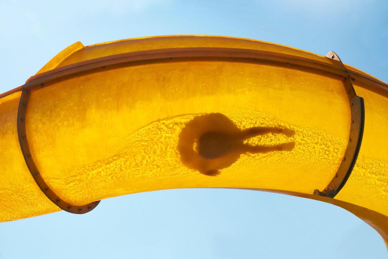 Silhouette of a person on a water slide