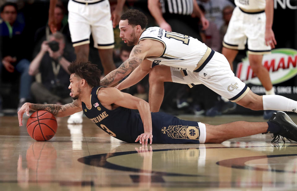 Notre Dame guard Prentiss Hubb, left, and Georgia Tech guard Jose Alvarado dive for the ball during the first half of an NCAA college basketball game Wednesday, Jan. 15, 2020, in Atlanta. (Curtis Compton/Atlanta Journal-Constitution via AP)