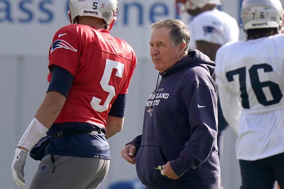 New England Patriots head coach Bill Belichick, center, speaks with quarterback Brian Hoyer (5) during an NFL football practice, Wednesday, Nov. 10, 2021, in Foxborough, Mass. (AP Photo/Steven Senne)