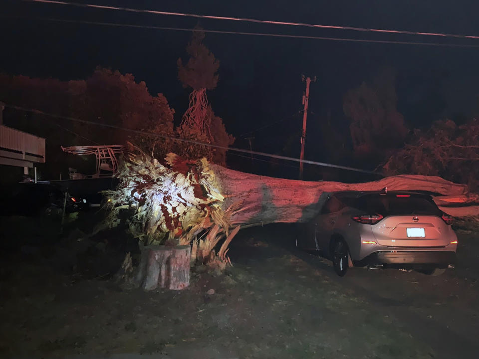 This early Monday, Oct. 11, 2021, photo provided by CalFire shows one of several vehicles damaged during a wind event in El Granada village in the coastal area of northern San Mateo County, Calif. (CalFire via AP)