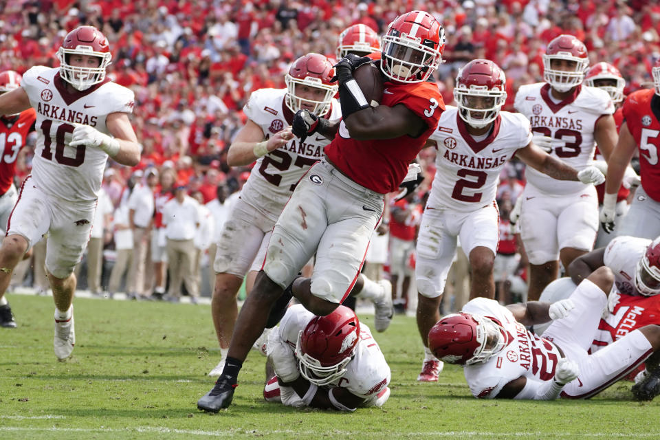 Georgia running back Zamir White (3) breaks through the Arkansas line as he runs for a touchdown during the second half of an NCAA college football game Saturday, Oct. 2, 2021, in Athens, Ga. (AP Photo/John Bazemore)