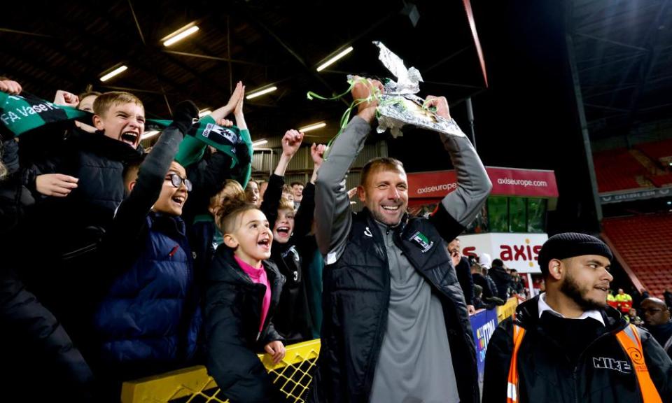 Cray Valley manager Steve McKimm celebrates with a replica of the FA Cup after holding Charlton to a 1-1 draw at The Valley