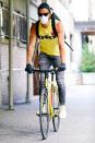 <p>Justin Theroux rides his bike in jeans and a tank top through New York City on Wednesday. </p>