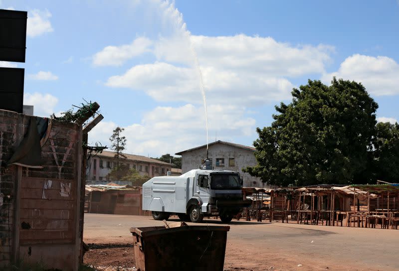 A police water canon sprays disinfectant over residential flats during a 21-day nationwide lockdown called to help curb the spread of coronavirus disease (COVID-19), in Harare