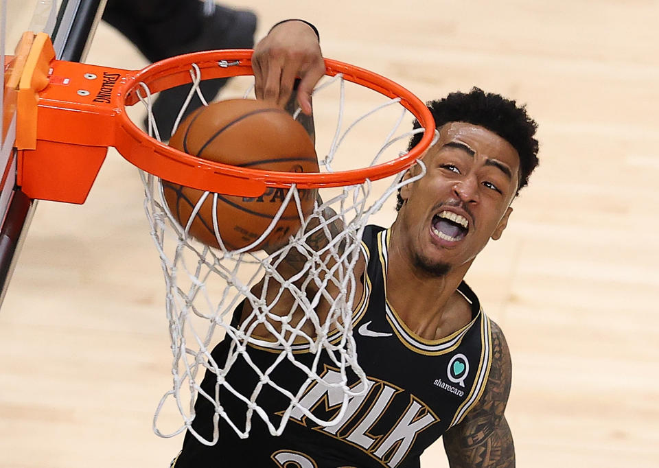 ATLANTA, GEORGIA - MAY 30:  John Collins #20 of the Atlanta Hawks dunks against the New York Knicks in the first half during game four of the Eastern Conference Quarterfinals at State Farm Arena on May 30, 2021 in Atlanta, Georgia.  NOTE TO USER: User expressly acknowledges and agrees that, by downloading and or using this photograph, User is consenting to the terms and conditions of the Getty Images License Agreement.  (Photo by Kevin C. Cox/Getty Images)