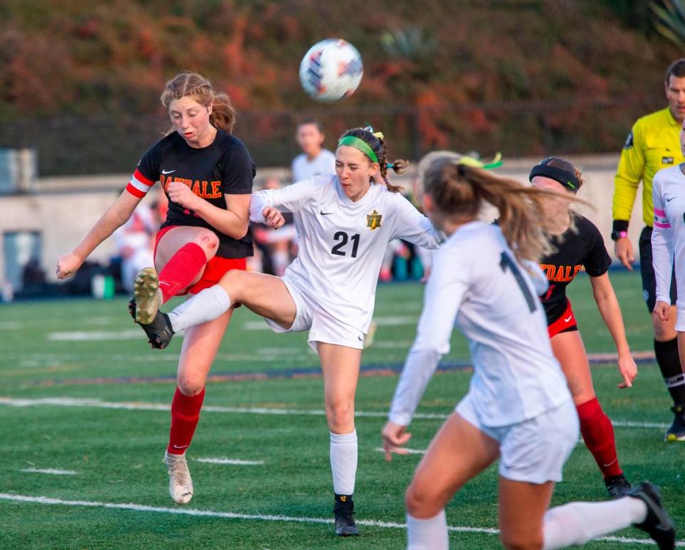 Oakdale High’s Claire McGee Brown, 11, fights for control of the ball against Delilah Oaks, 21 of Rio Americano High during the Sac-Joaquin Section Division III Section Championship match Thursday Feb. 22, 2024 at Cosumnes River College.