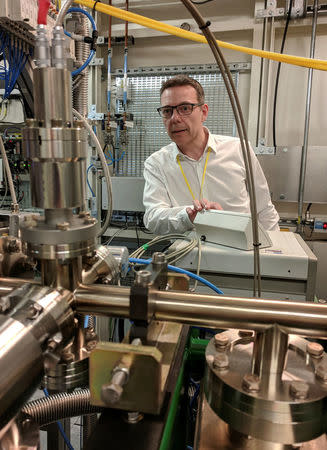 Professor John McGeehan, an X-ray Crystallographer at the University of Portsmouth, stands next to equipment at the Diamond Light Source, the UK national synchrotron, that he used to reveal the atomic structure of an enzyme his team has subsequently engineered that can digest a common form of plastic and may in future help in the fight against pollution, in Didcot, Britain, April 13, 2018. REUTERS/Stuart McDill