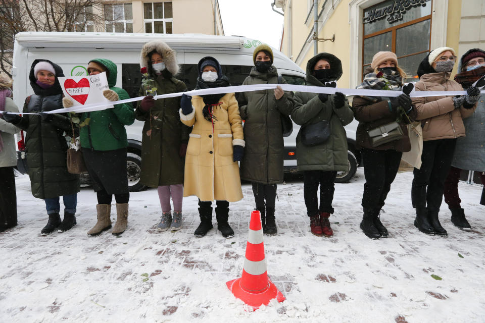 Women, some of them wearing face masks to protect against coronavirus, attend a rally in support of jailed opposition leader Alexei Navalny, and his wife Yulia Navalnaya at Arbat street in Moscow, Russia, Sunday, Feb. 14, 2021. The weekend protests in scores of cities last month over Navalny’s detention represented the largest outpouring of popular discontent in years and appeared to have rattled the Kremlin. (AP Photo/Alexander Zemlianichenko)