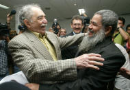 FILE - In this Dec. 16, 2005 file photo, Colombian Nobel laureate Gabriel Garcia Marquez, left, greets National Liberation Army (ELN) spokesperson Francisco Galan before a meeting between Colombia's government and the ELN in Havana, Cuba. Marquez died on Thursday, April 17, 2014 at his home in Mexico City. (AP Photo/Jorge Rey, File)