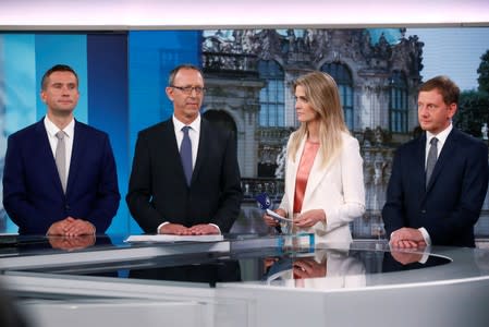 Top candidates for the Saxony election Martin Dulig, Joerg Urban and Michael Kretschmer appear in the TV studio after the announcement of first exit polls for the Saxony state election in Dresden