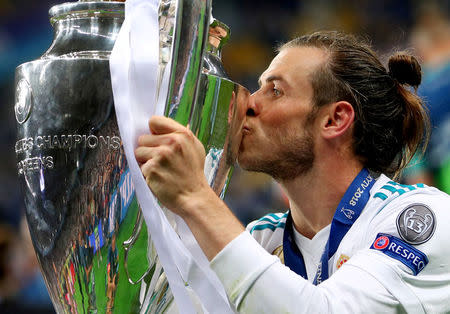 Soccer Football - Champions League Final - Real Madrid v Liverpool - NSC Olympic Stadium, Kiev, Ukraine - May 26, 2018 Real Madrid's Gareth Bale celebrates winning the Champions League by kissing the trophy REUTERS/Hannah McKay