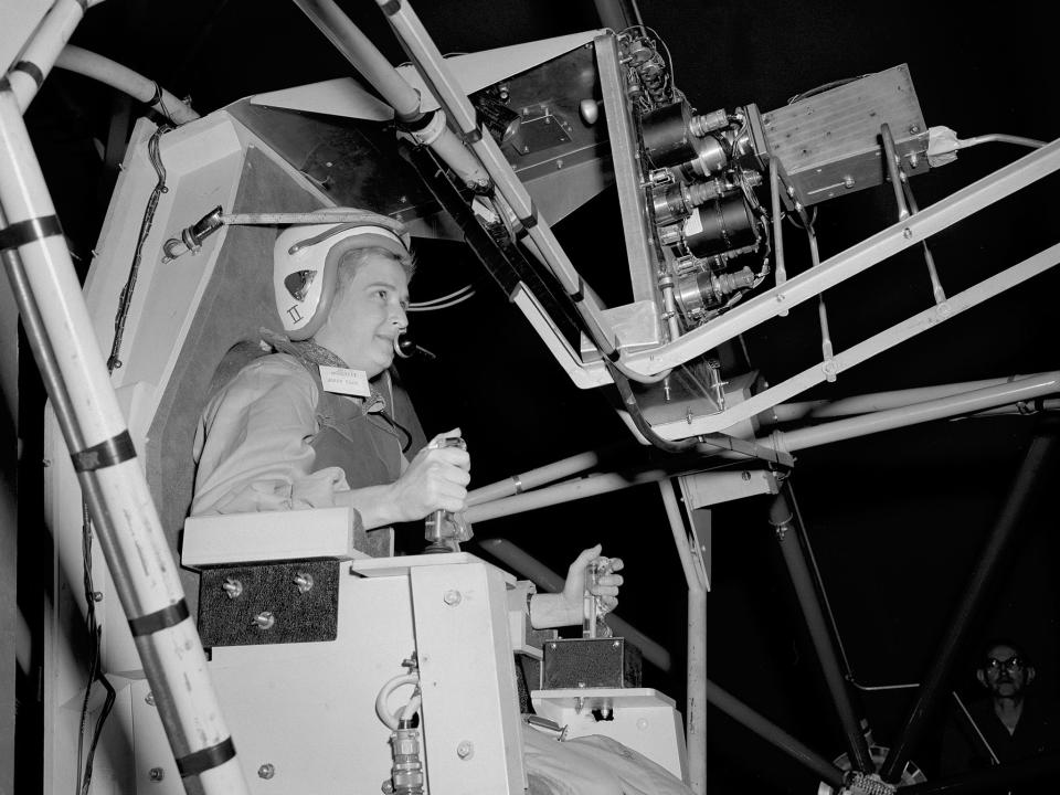 In this 1960 photo made available by NASA, Jerrie Cobb prepares to operate the Multi-Axis Space Test Inertia Facility (MASTIF) at the Lewis Research Center in Ohio. The three-axis rig was developed to train Project Mercury pilots in bringing a spinning spacecraft under control. The two controllers in Cobb's hands activated small nitrogen gas thrusters that were used to bring the MASTIF under control. She was one of several female pilots who underwent the skill and endurance testing that paralleled that of the Project Mercury astronauts. In 1961 Jerrie Cobb was the first female to pass all three phases of the Mercury Astronaut Program. NASA rules, however, stipulated that only military test pilots could become astronauts and there were no female military test pilots. Cobb, NASA’s first female astronaut candidate, died in Florida at the age of 88 on March 18, 2019. (NASA via AP)
