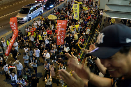Demonstrators cheer up during a protest to demand authorities scrap a proposed extradition bill with China, in Hong Kong, China April 28, 2019. REUTERS/Tyrone Siu