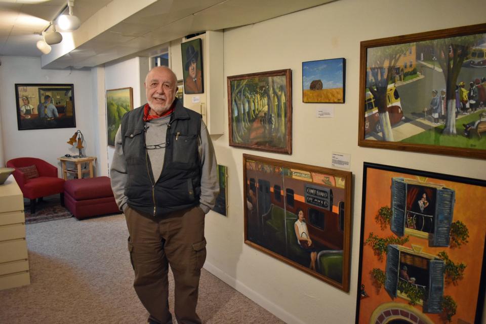 The walls of Joe Geha's home office is filled with his paintings, a hobby he began after retiring as a creative writing professor at Iowa State University.
