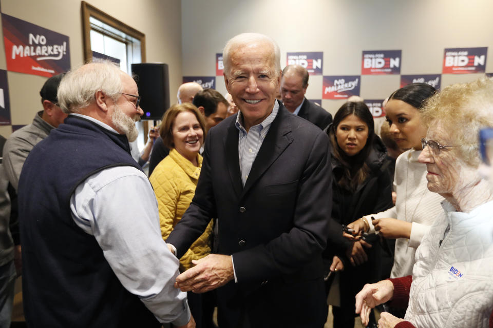 Democratic presidential candidate former Vice President Joe Biden greets audience members during a stop on his bus tour, Monday, Dec. 2, 2019, in Emmetsburg, Iowa. (AP Photo/Charlie Neibergall)