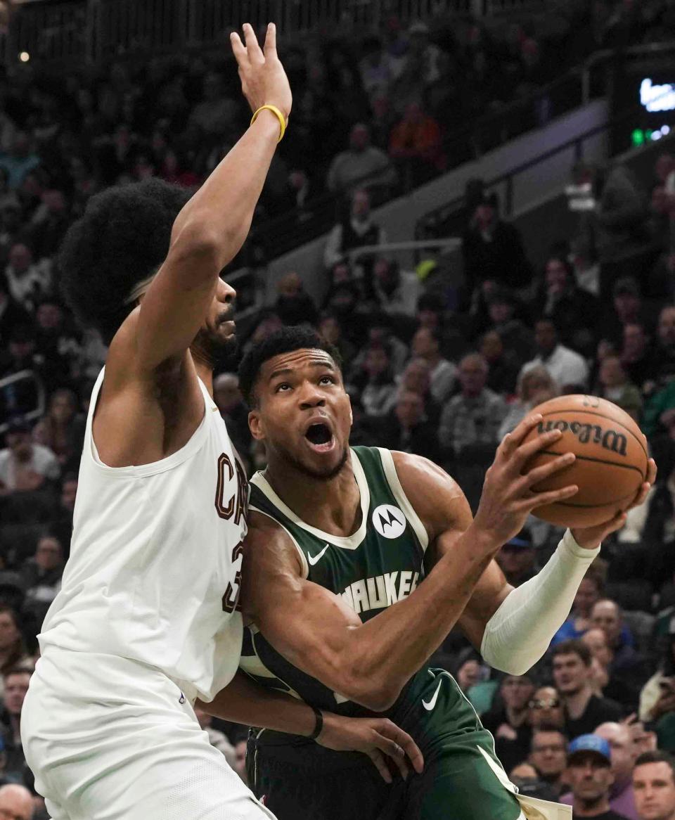 Bucks forward Giannis Antetokounmpo leans into  Cavaliers center Jarrett Allen while going up for a shot Wednesday night at Fiserv Forum.