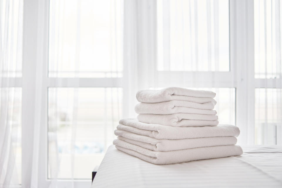 White folded sheets and towels in a neat pile