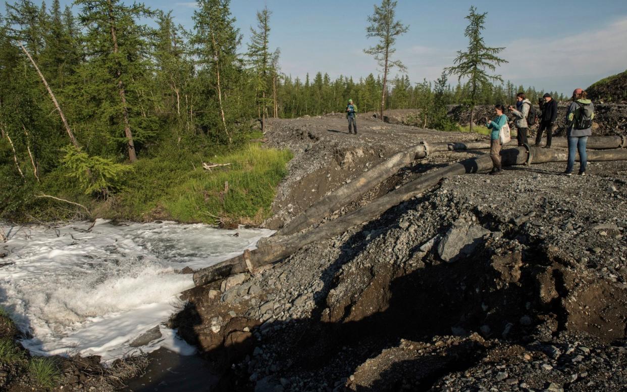 Water from the Norilsk Nickel enrichment plant gushing out of a pipe and into a river - Dmitry Sharomov/Greenpeace via AP