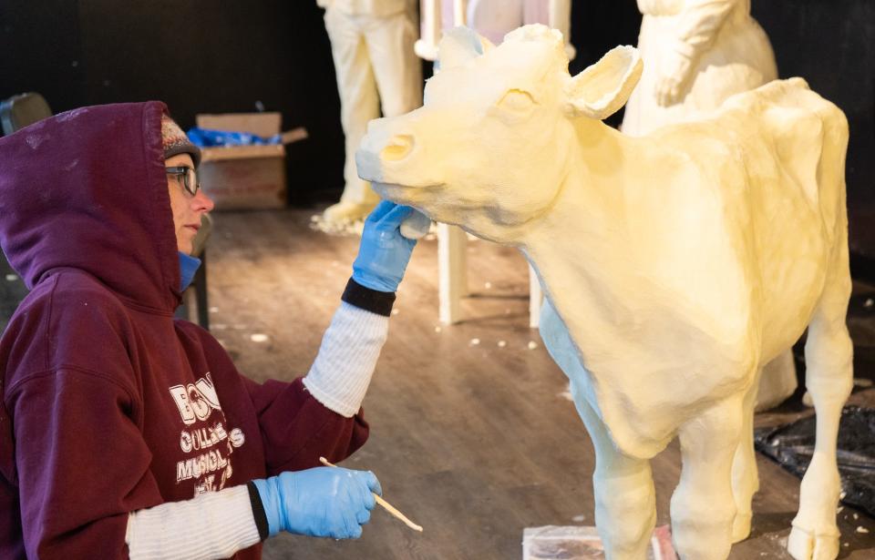 Tammy Buerk of West Chester works on the butter calf sculpture for the American Dairy Association Mideast’s butter cow display at the Ohio State Fair.