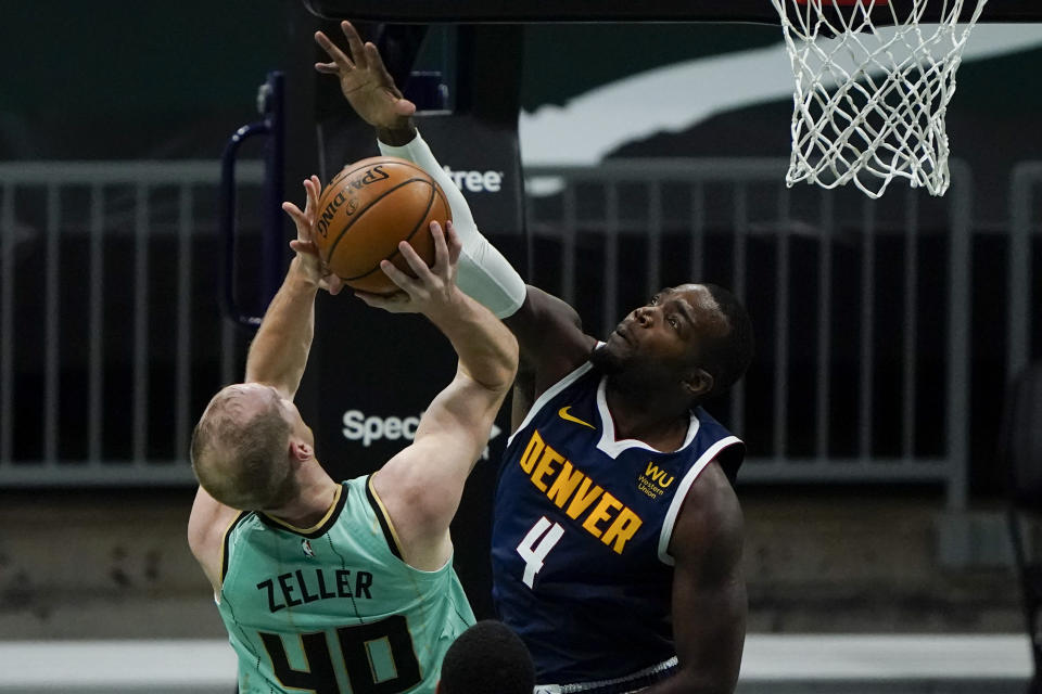 Denver Nuggets forward Paul Millsap blocks a shot by Charlotte Hornets center Cody Zeller during the first half of an NBA basketball game on Tuesday, May 11, 2021, in Charlotte, N.C. (AP Photo/Chris Carlson)
