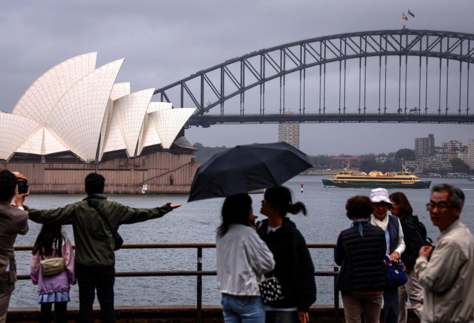 A woman suffered serious leg injuries after being attacked Monday by a suspected bull shark in Sydney Harbor near the Sydney Opera House, which is seen pictured in December 2023.