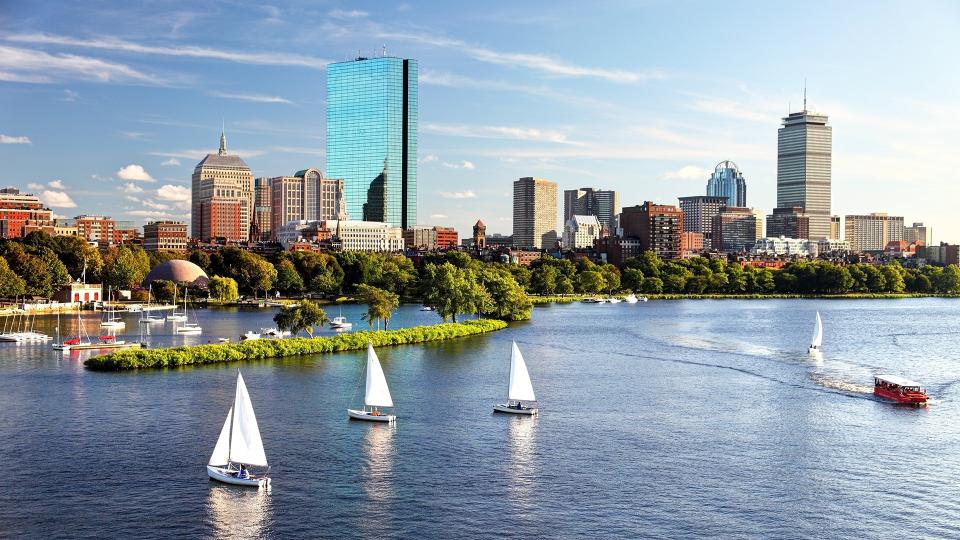 Sailboats on the Charles River with Boston's Back Bay skyline in the background.