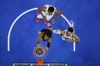 Atlanta Hawks' John Collins, center, dunks the ball past Philadelphia 76ers' Joel Embiid, left, and Tobias Harris during the second half of Game 7 in a second-round NBA basketball playoff series, Sunday, June 20, 2021, in Philadelphia. (AP Photo/Matt Slocum)