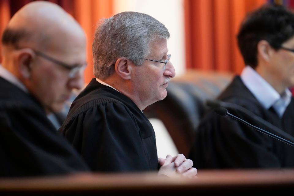Colorado Supreme Court Justice Richard L. Gabriel listens during a hearing in the court on Wednesday, Dec. 6, 2023, in Denver. The oral arguments before the court were held after both sides appealed a ruling by a Denver district judge on whether to allow former President Donald Trump to be included on the state's general election ballot.