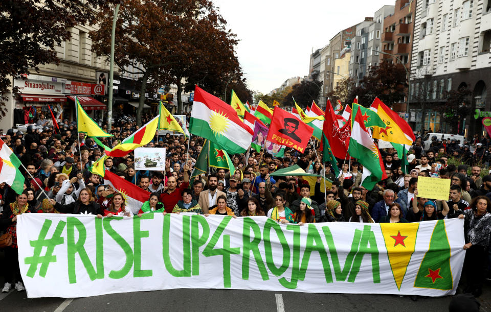 Kurdish protesters in Berlin, Germany, carry a banner during a demonstration on Oct. 12 against Turkey's military action in northeastern Syria. (Photo: Christian Mang / Reuters)