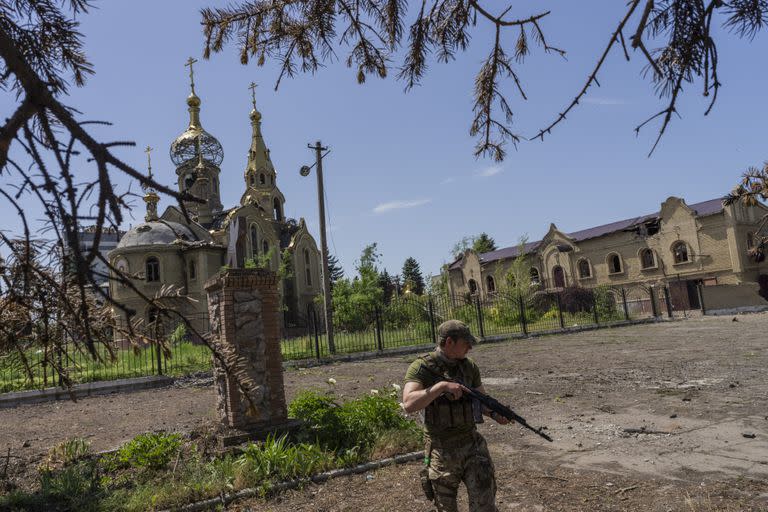 Un soldado ucraniano patrulla un pueblo cerca del frente de batalla en la región de Donetsk. (AP Photo/Bernat Armangue)