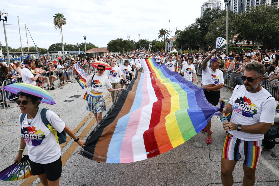 A long Pride flag is carried during the St. Pete Pride Parade along Bayshore Drive on Saturday, June 24, 2023, in St. Petersburg, Fla. (Jefferee Woo/Tampa Bay Times via AP)