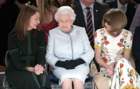 Britain's Queen Elizabeth II sits next to Vogue Editor-in-Chief Anna Wintour and Caroline Rush, Chief Executive of the British Fashion Council, as they view Richard Quinn's runway show before presenting him with the inaugural Queen Elizabeth II Award for British Design as she visits London Fashion Week, in London, Britain February 20, 2018. REUTERS/Yui Mok/Pool