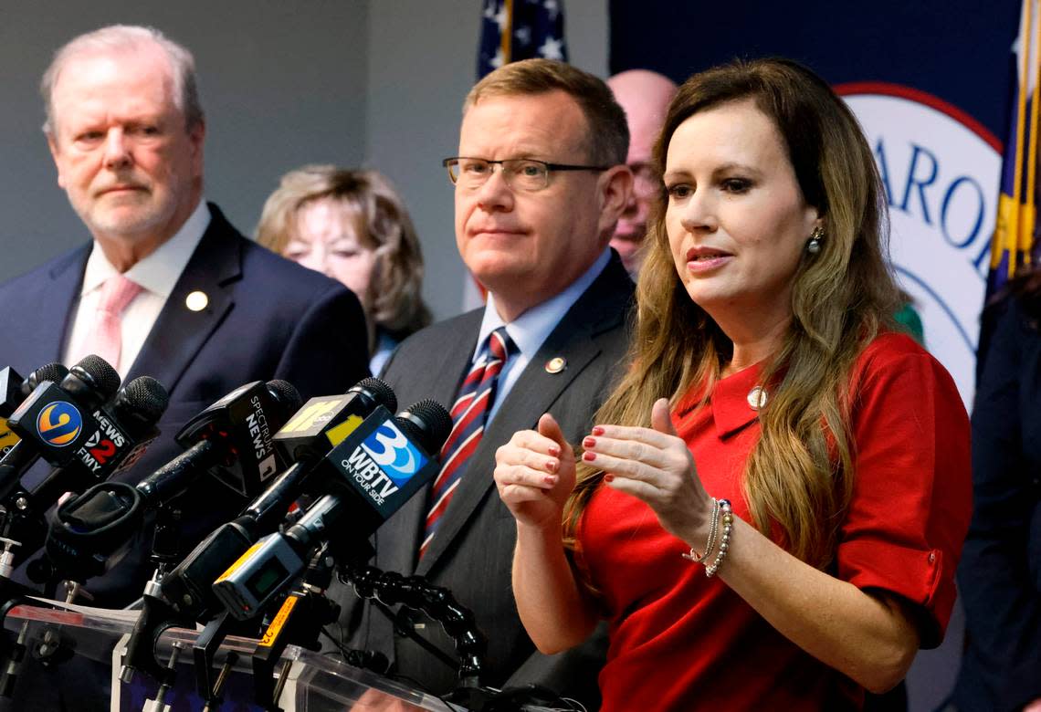 N.C. Senate leader Phil Berger, left, and House Speaker Tim Moore, center, look on as N.C. Rep. Tricia Cotham speaks during a press conference at the N.C. GOP headquarters in Raleigh, N.C. Wednesday, April 5, 2023. The press conference was to announce Rep. Cotham is switching parties to become a member of the House Republican caucus.
