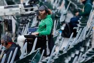 <p>Oakland Athletics pitcher Dallas Braden is seen in the stands near cutouts of fans as he prepares to do play-by-play during their Bay Bridge Series game against the San Francisco Giants at the Coliseum in Oakland on Monday July 20.</p>