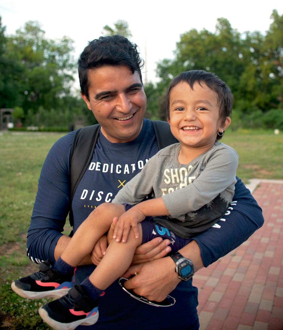 Niamatullah Abdul Rauf poses for a photo with his son Hekmatullah, 3.