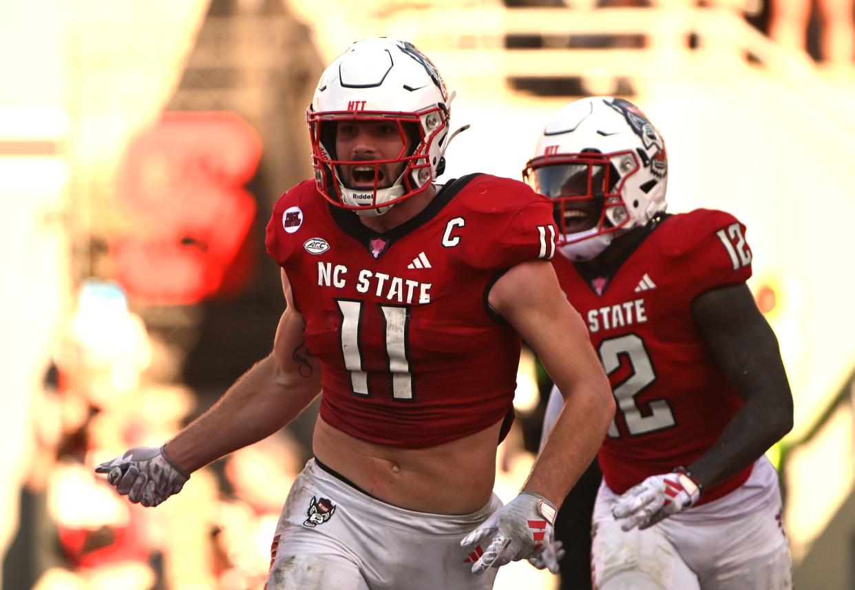 North Carolina State linebacker Payton Wilson (11) celebrates after scoring a touchdown on an interception return Oct. 28, 2023, against the Clemson Tigers in Raleigh, N.C.