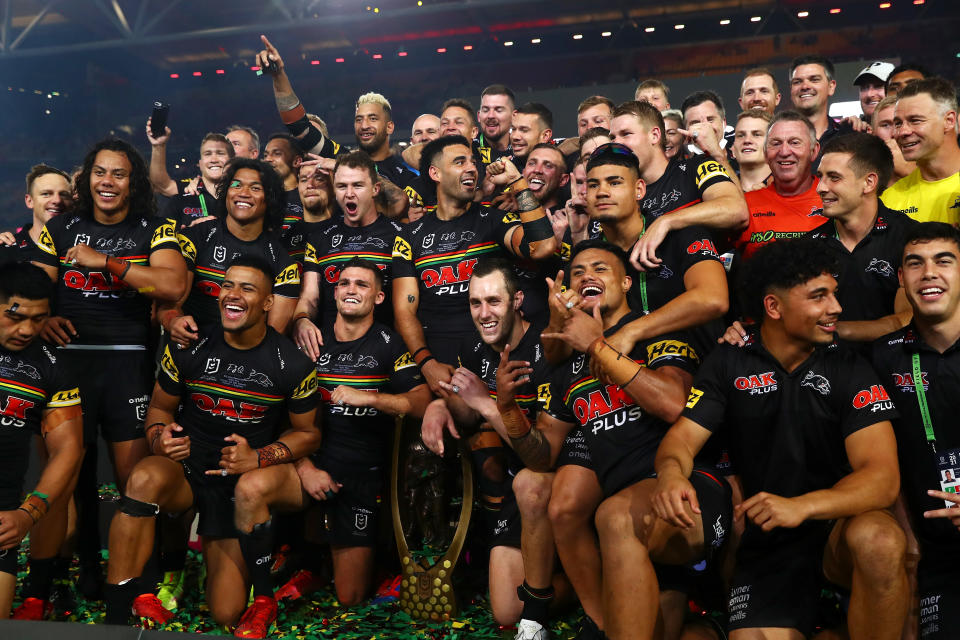 Seen here, Panthers players pose with the NRL Premiership Trophy after their 14-12 victory over the Rabbitohs.