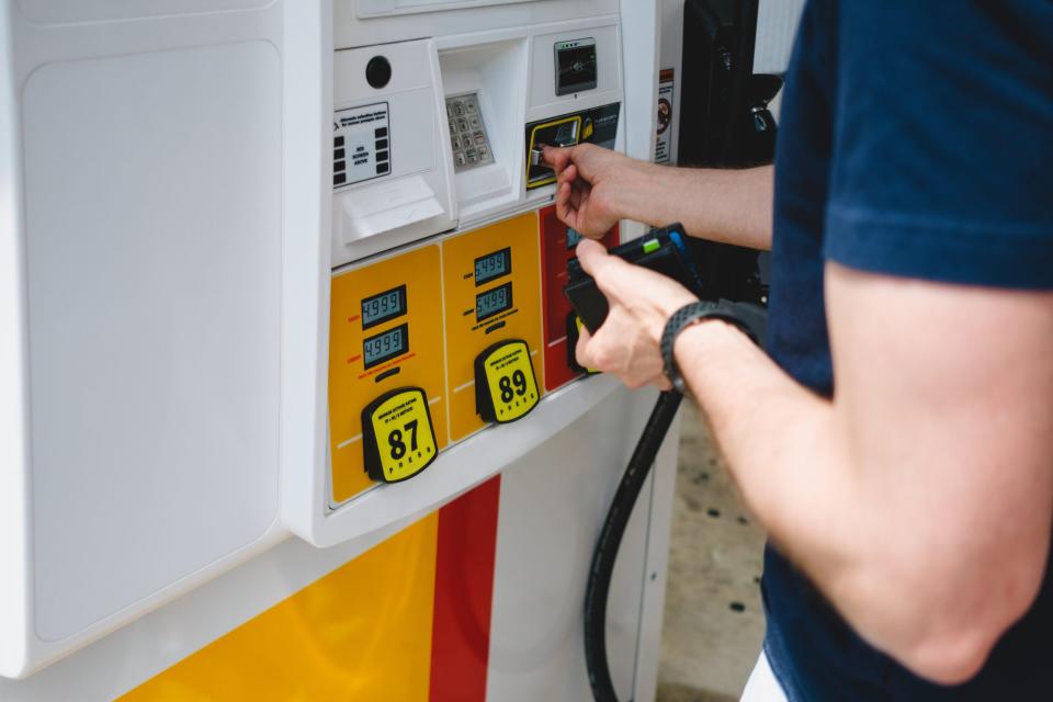Close-up of unrecognizable white man purchasing gas at pump