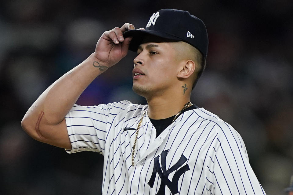 New York Yankees relief pitcher Jonathan Loaisiga adjusts his cap after the Houston Astros scored during the seventh inning of Game 4 of an American League Championship baseball series, Sunday, Oct. 23, 2022, in New York. (AP Photo/John Minchillo)