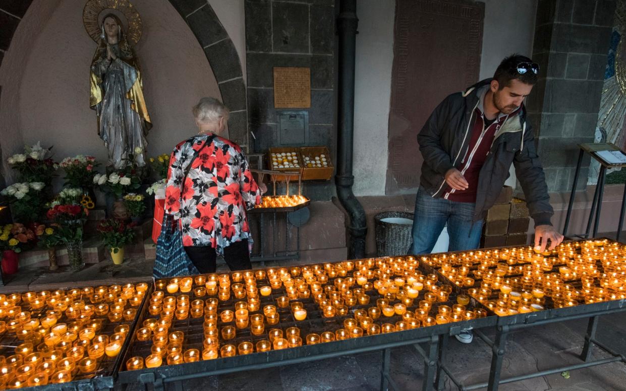 People light candles to the Virgin Mary at Liebfrauenkirche, Frankfurt